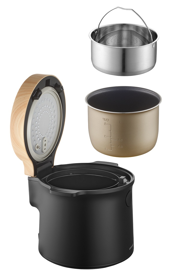 Elektryczny garnek do ryżu z częściami: kosz do gotowania na parze, garnek wewnętrzny i pokrywa. Czarna podstawa, drewniany detal pokrywy. Na białym tle.