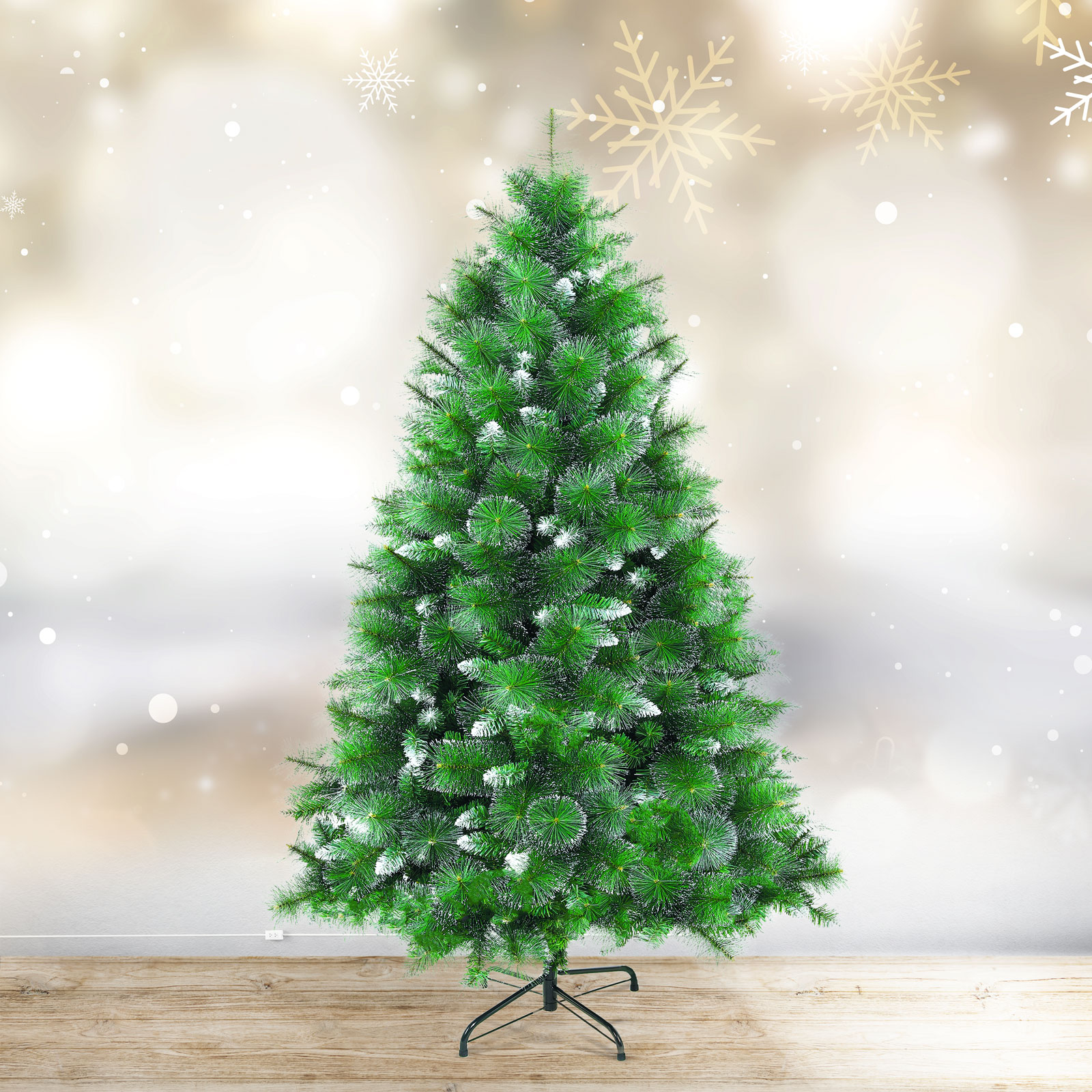 Zöld karácsonyfa fehér díszítéssel, fa padlón, hópehely a háttérben.