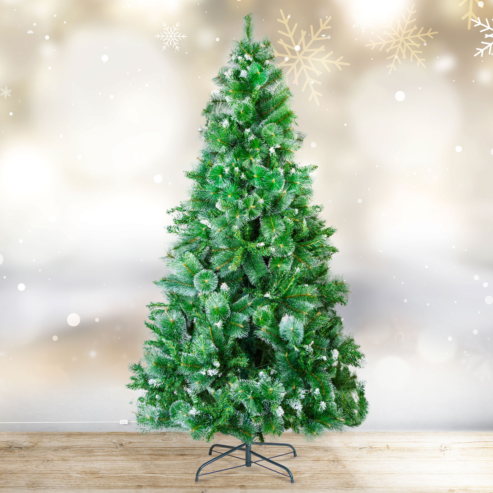 Egy zöld karácsonyfa fehér díszítéssel fa padlón, hópihék a háttérben.