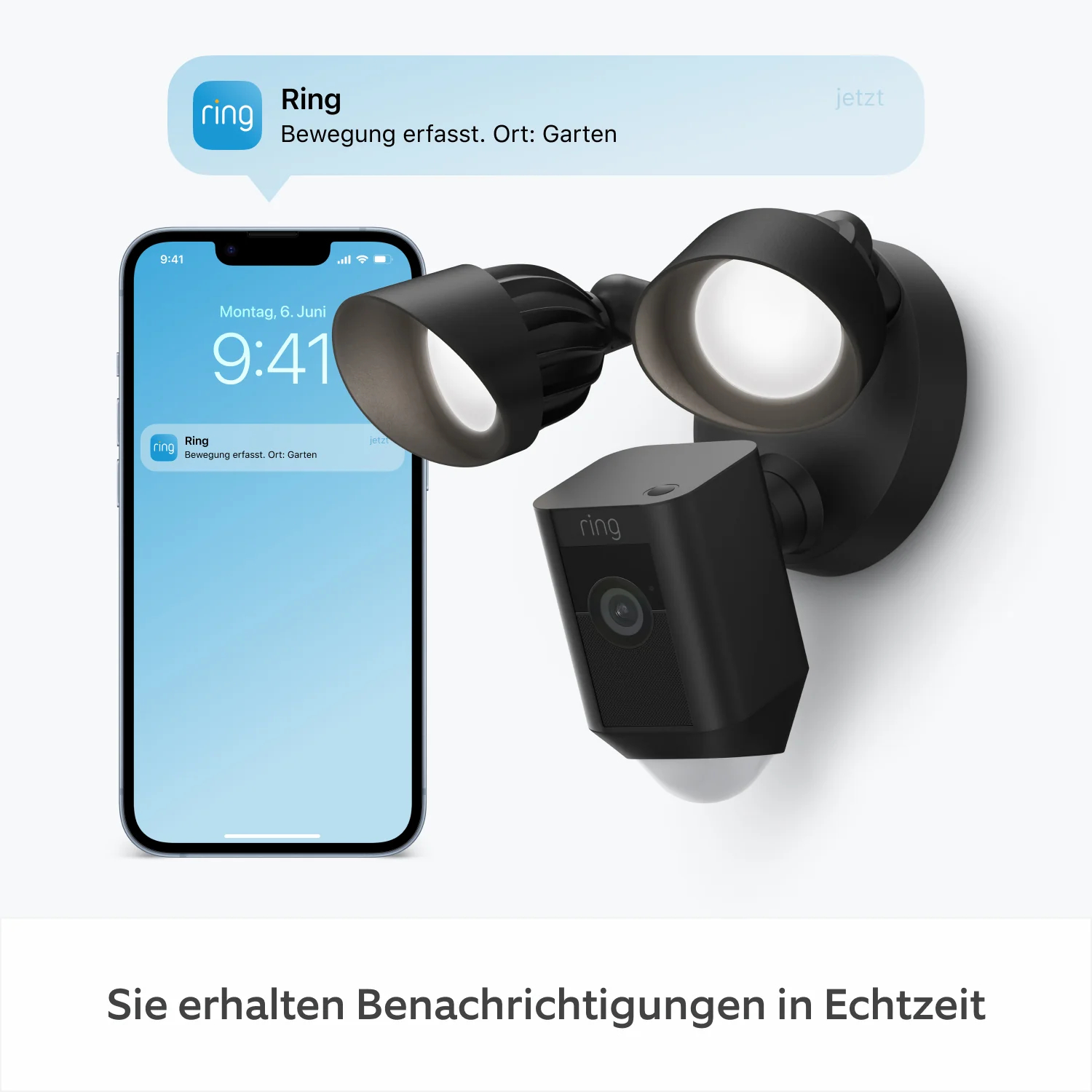 Eine schwarze Ring-Überwachungskamera und ein Flutlicht neben einem Smartphone, das eine Benachrichtigung anzeigt.