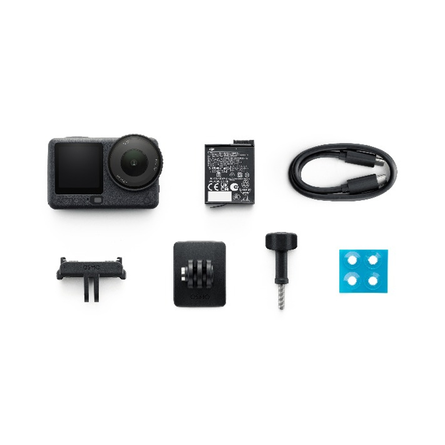 Vista dall'alto di una fotocamera e accessori su sfondo bianco. Include fotocamera, batteria, cavo, supporti, vite e cuscinetti adesivi.
