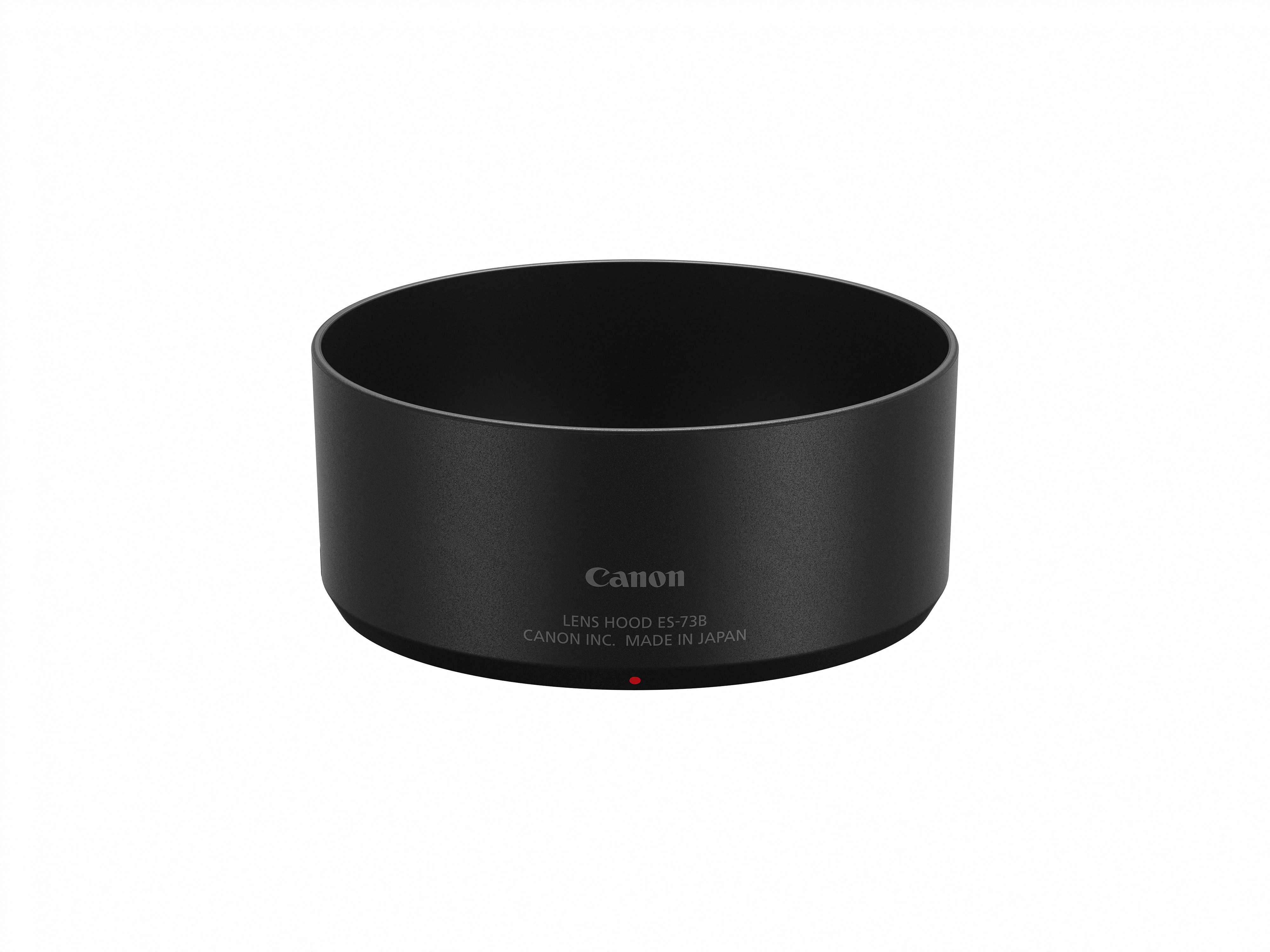 Schwarze Canon-Objektivblende auf Weiß. Sie trägt den Text: Canon, Lens Hood ES-73B, Canon Inc. Made in Japan, und einen roten Punkt.