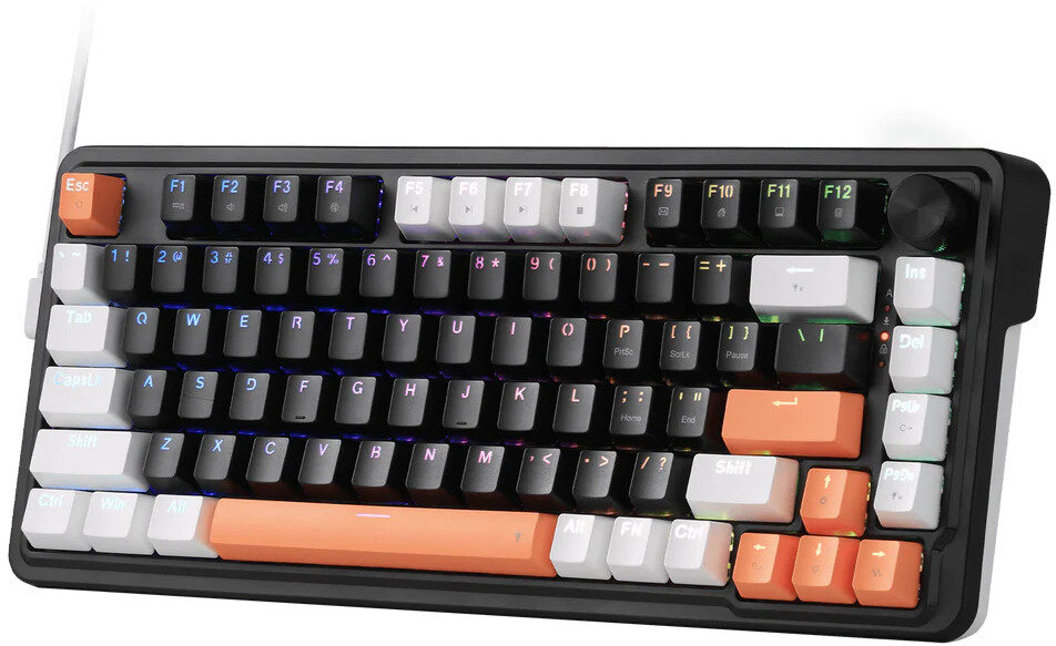 Wyświetlana jest czarno-pomarańczowa klawiatura mechaniczna. Ma białe i pomarańczowe klawisze. Po prawej stronie znajduje się czarne pokrętło.