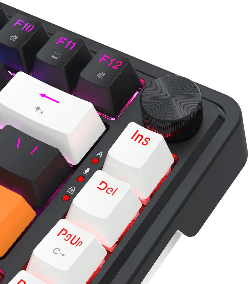 Zbliżenie czarno-białej klawiatury z podświetlonymi klawiszami. Zawiera pokrętło głośności i czerwone wskaźniki.