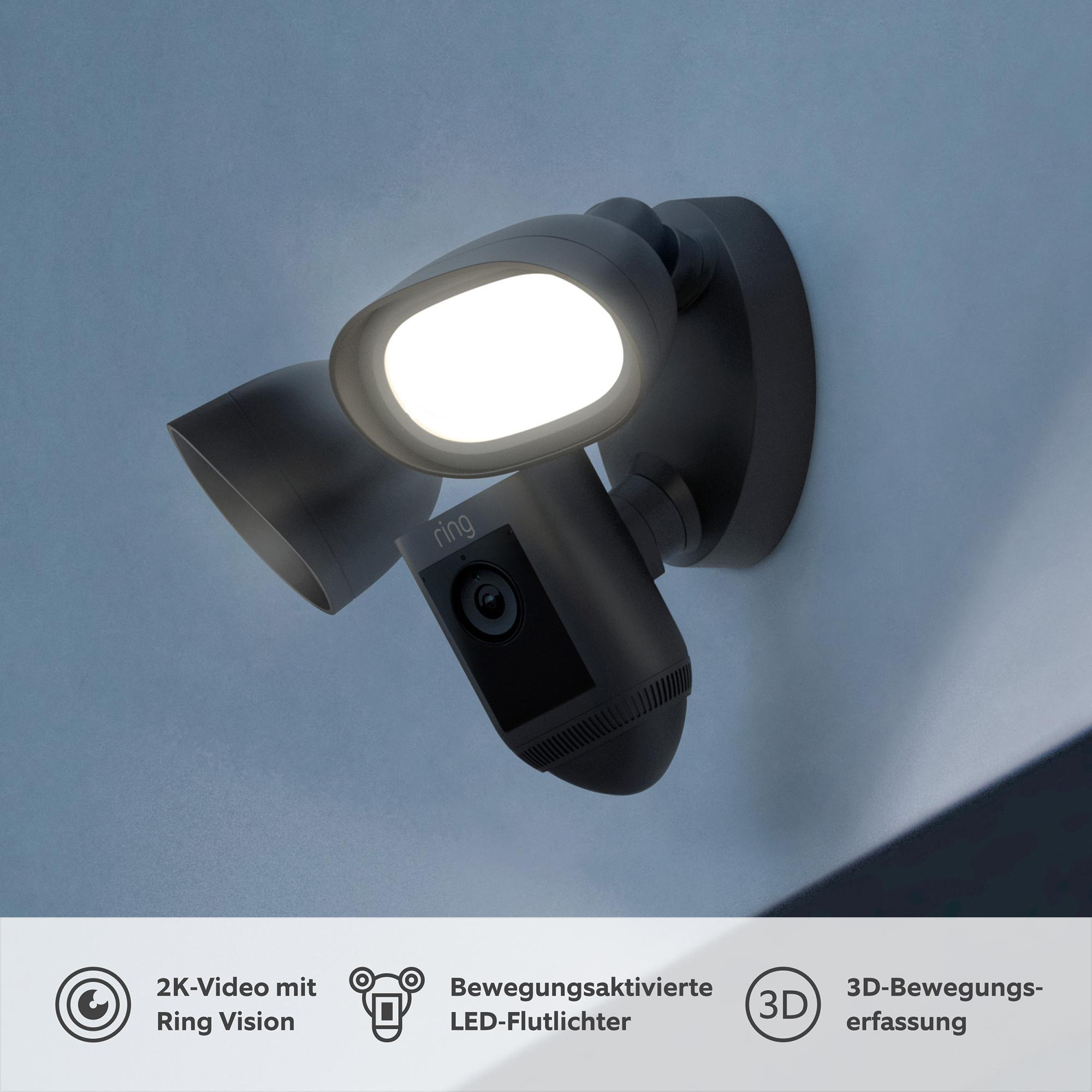 Schwarzes Ring-Sicherheitslicht mit Kamera. Es hat zwei Lichter und eine Kamera, die an einer Wand montiert sind.