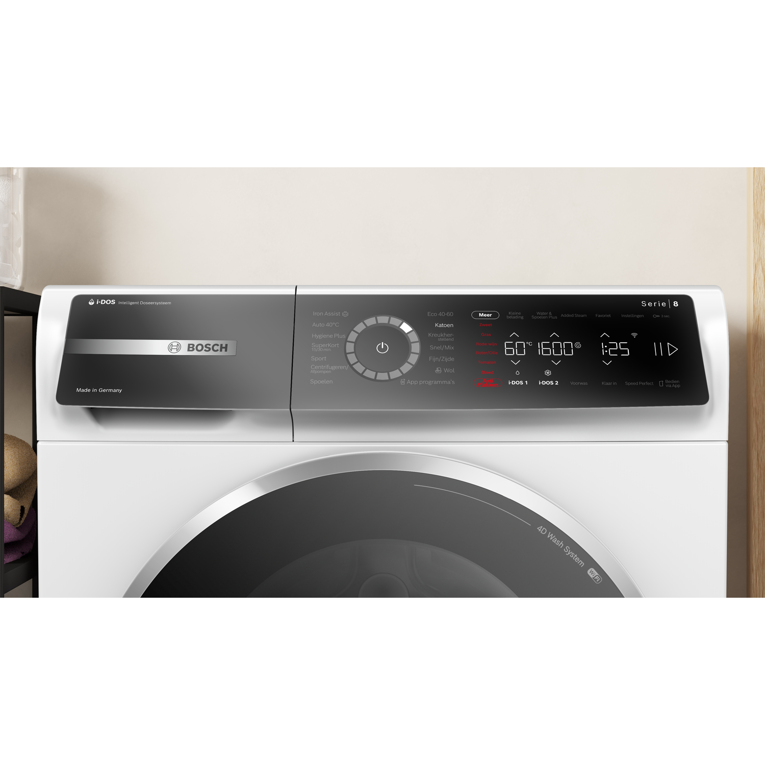 A white Bosch washing machine control panel is visible. It has buttons and a digital display showing settings and time.