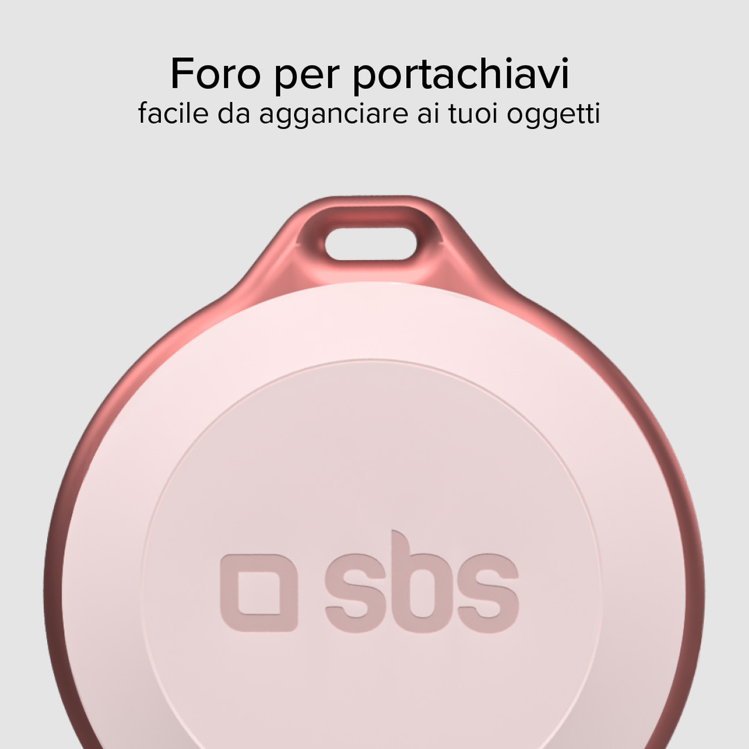 Un portachiavi circolare rosa e bianco con la scritta 'sbs'. Ha un foro in alto per un facile aggancio.