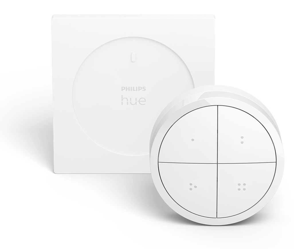 Fehér Philips Hue okosotthon-eszköz. Négyzet alakú alapból és kör alakú távirányítóból áll, négy gombbal.