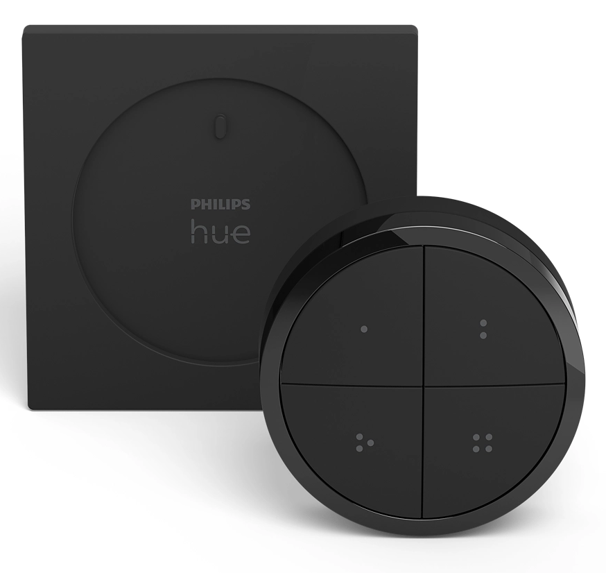 Fekete Philips Hue okosotthon vezérlők. Négyzet alakú fali tartó és kerek távirányító, négy gombbal, mindegyiken pontokkal, fehér háttéren.