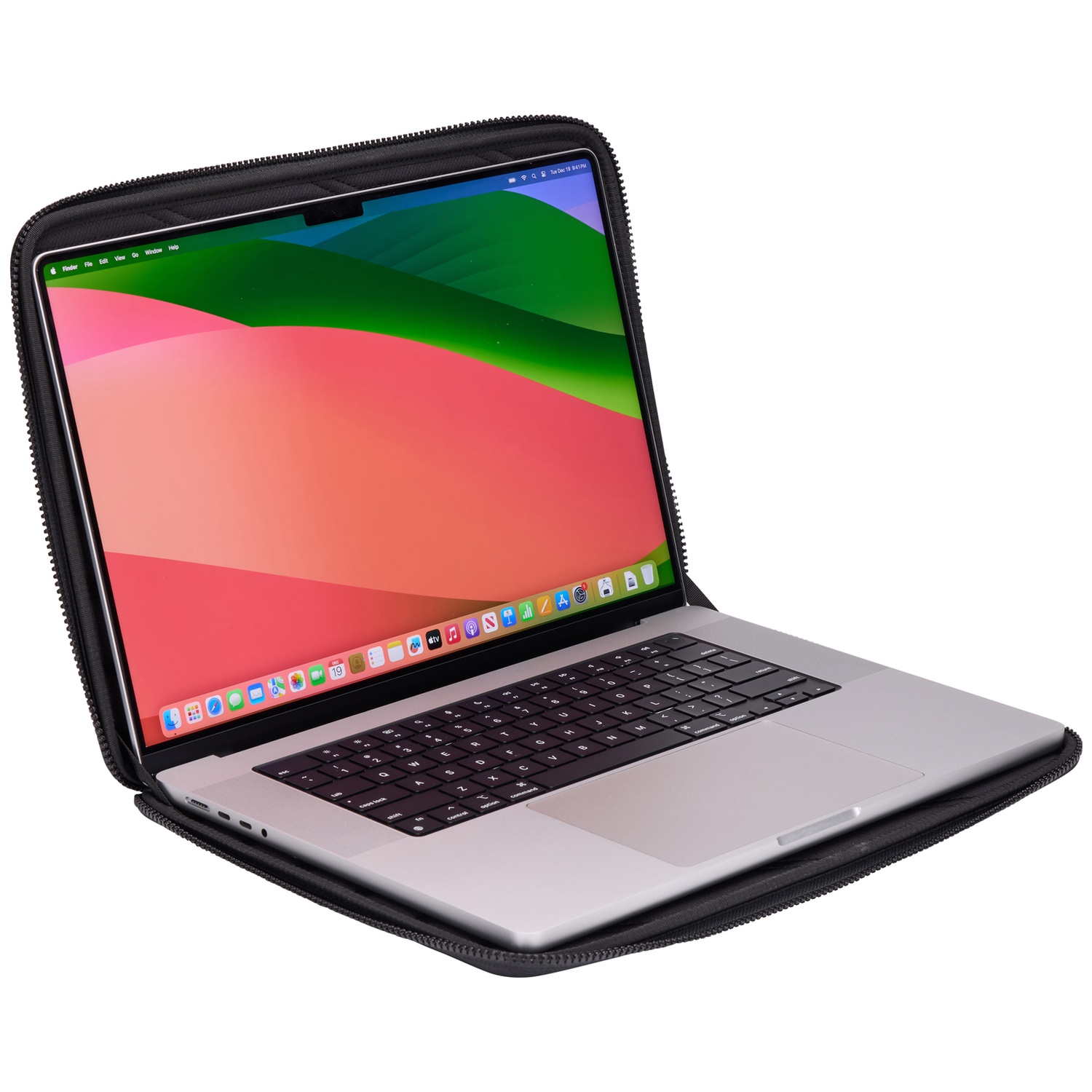 Open laptop in a black case. The screen displays a colorful desktop. Keyboard visible. The laptop rests on a white surface.