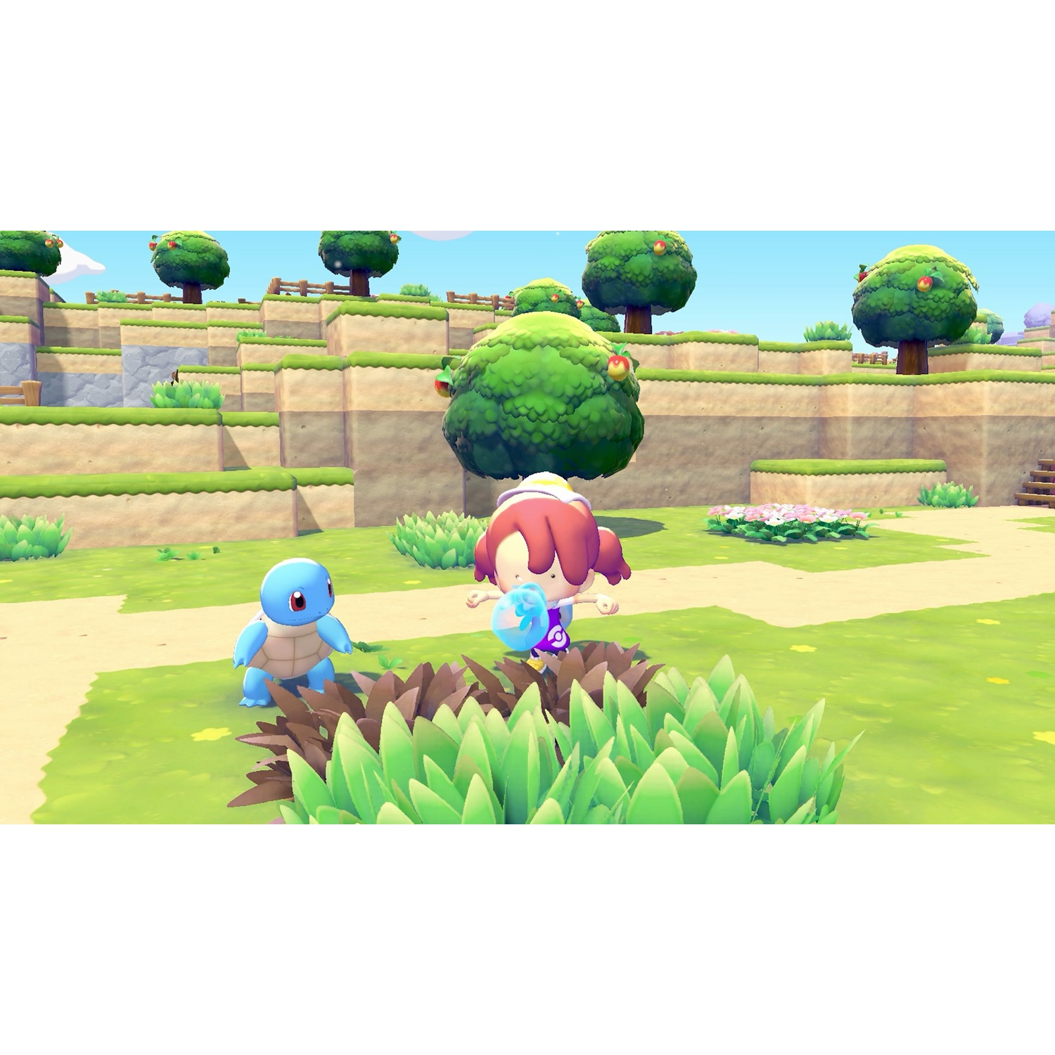 A cartoon scene shows a girl with Squirtle. They are on a grassy hill with trees and flowers. The sky is blue and sunny.