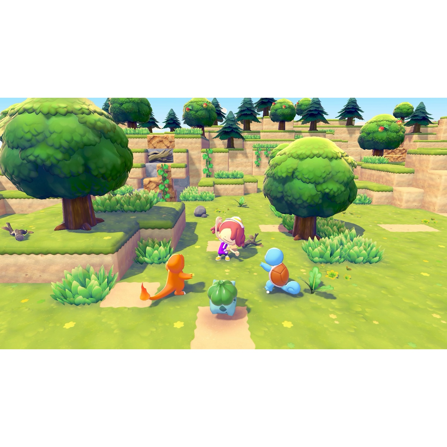 Une scène de dessin animé avec une personne et trois Pokémon dans un champ vert. Des arbres et des collines sont en arrière-plan.