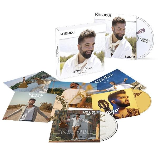 Des pochettes d'albums et des CD de Kendji Girac sont affichés. Les pochettes présentent l'artiste. Une guitare est visible sur quelques pochettes.