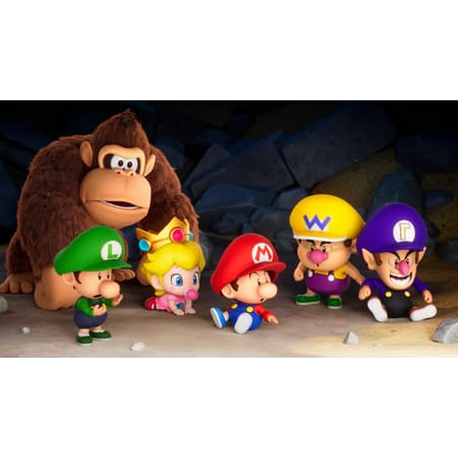 Donkey Kong met Baby Luigi, Peach, Mario, Wario en Waluigi figuren. Ze staan op een stenen oppervlak, voor een donkere grotmuur.
