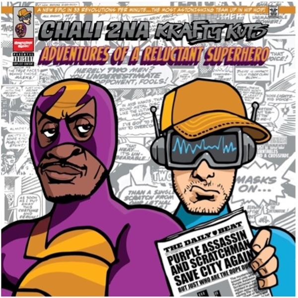 Comic-Cover mit zwei Männern: einer in lila Superheldenanzug, der andere mit Mütze und Zeitung.
