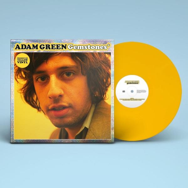 Albumcover: Adam Green. Gelbe Schallplatte. Das Album heißt 'Gemstones'. Der Hintergrund ist hellblau.