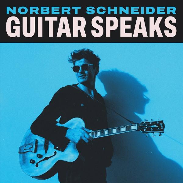 Mann mit Sonnenbrille hält Gitarre. Blauer Hintergrund mit Text 'NORBERT SCHNEIDER GUITAR SPEAKS'.