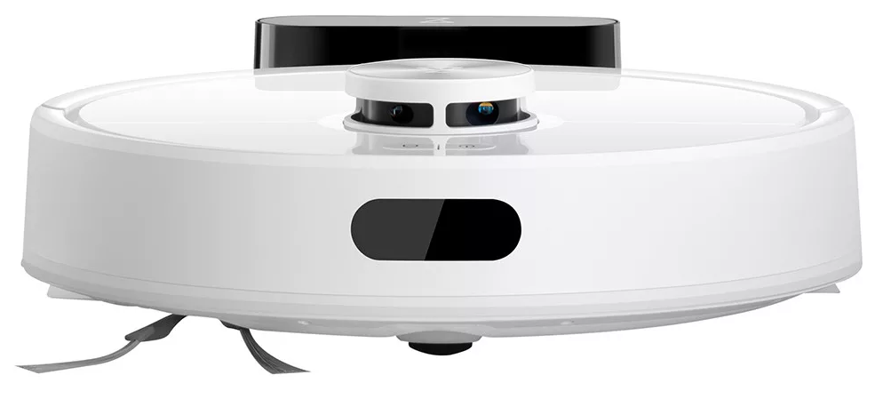 Egy fehér és fekete robotporszívó. Kör alakú teste van, érzékelőkkel és látható kefékkel. A tetején egy fekete rész található.
