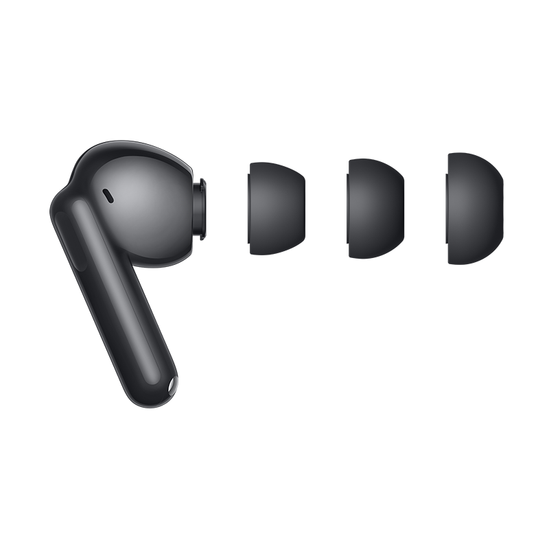 Czarny bezprzewodowy pączek z trzema wymiennymi końcówkami na ciemnoszarej powierzchni. Słuchawka jest elegancka.