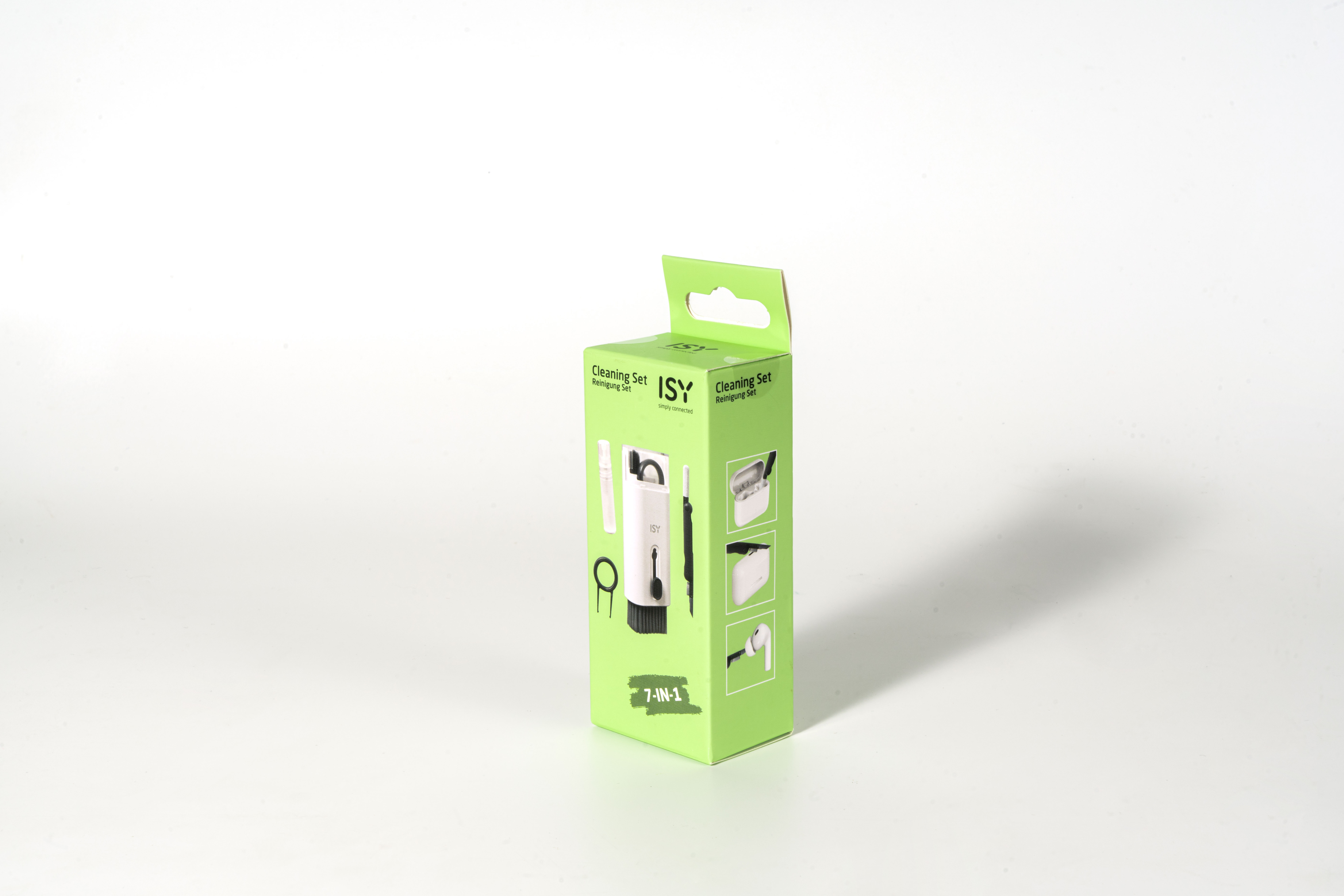 Zielone pudełko z zestawem do czyszczenia 7 w 1 stoi na białej powierzchni. Pudełko zawiera zdjęcia narzędzi do czyszczenia.