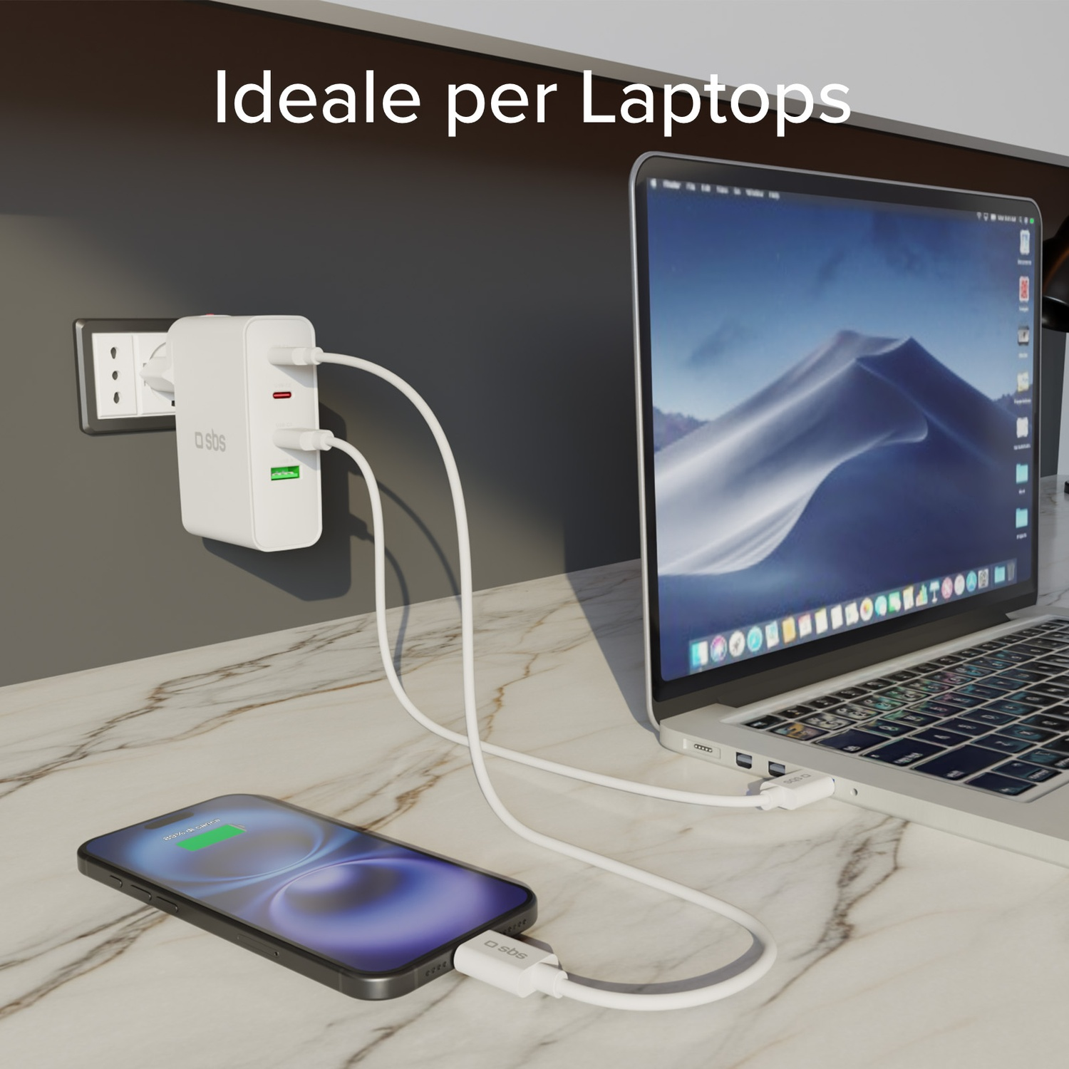 Un laptop, un telefono e una stazione di ricarica con cavi bianchi su una superficie di marmo. Il telefono e il laptop sono in carica.