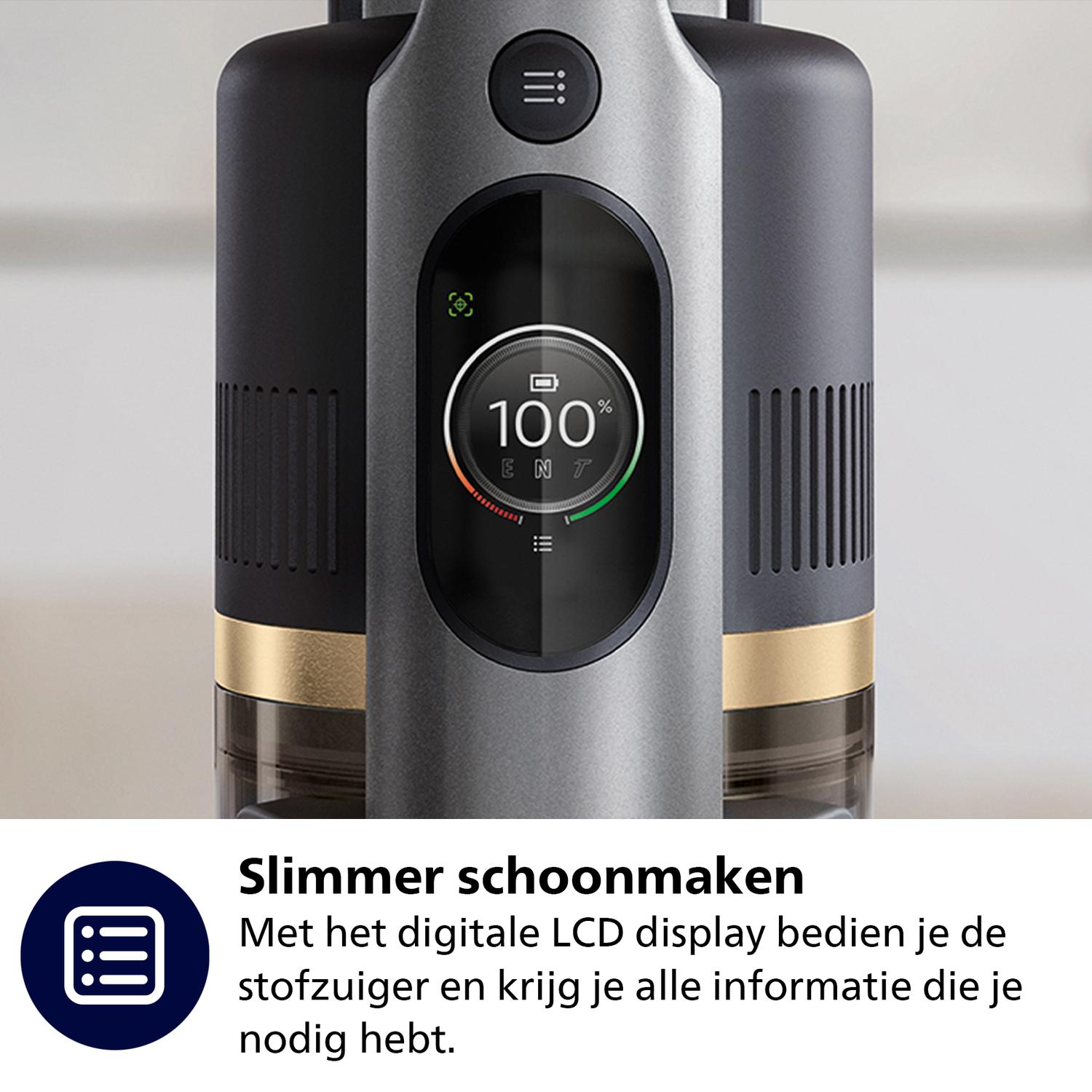 A gray and black vacuum cleaner with an LCD screen displaying battery percentage. The screen shows 100% and a charge indicator.