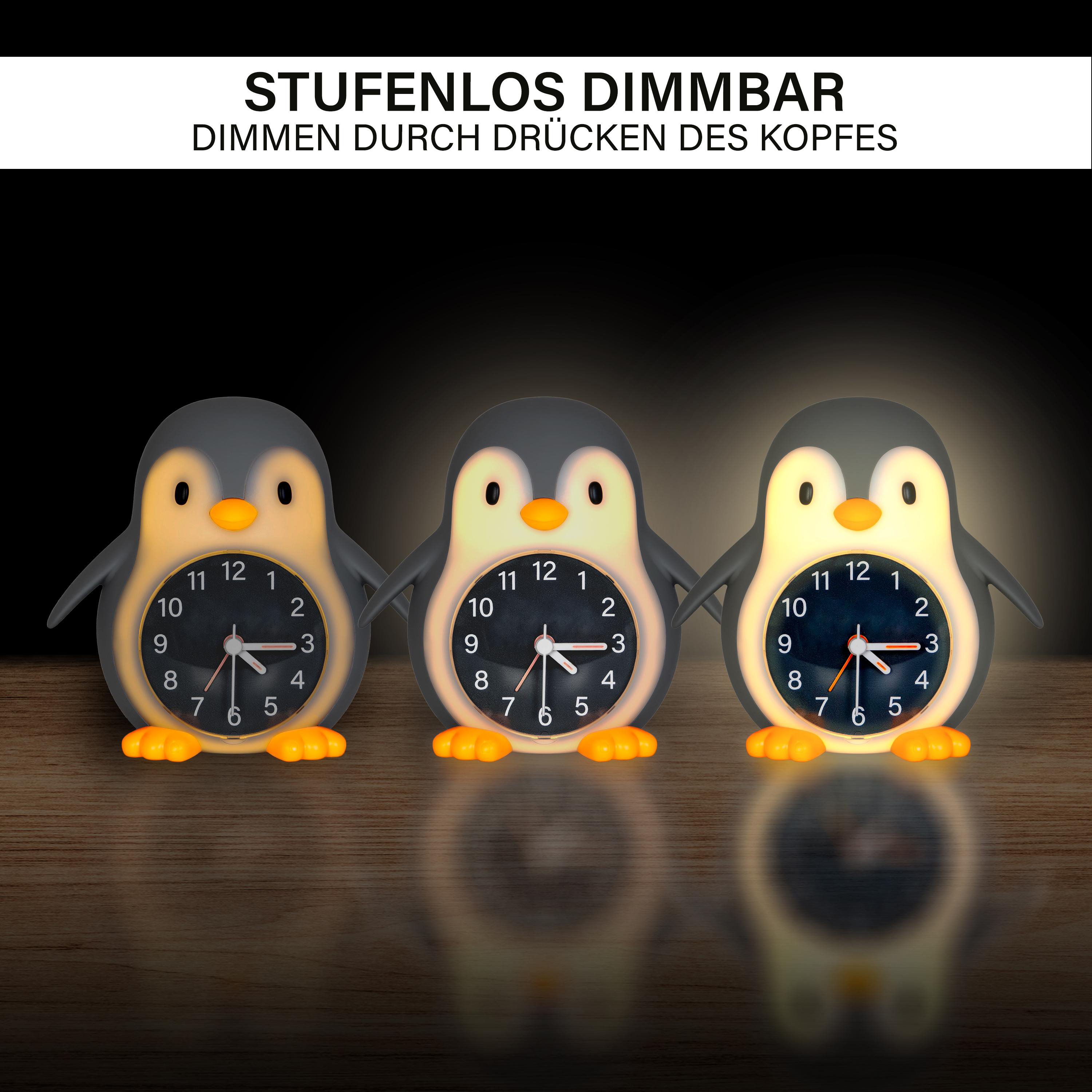 Drei pinguinförmige Uhren mit leuchtenden Gesichtern. Jede zeigt eine andere Zeit auf Holzoberfläche.