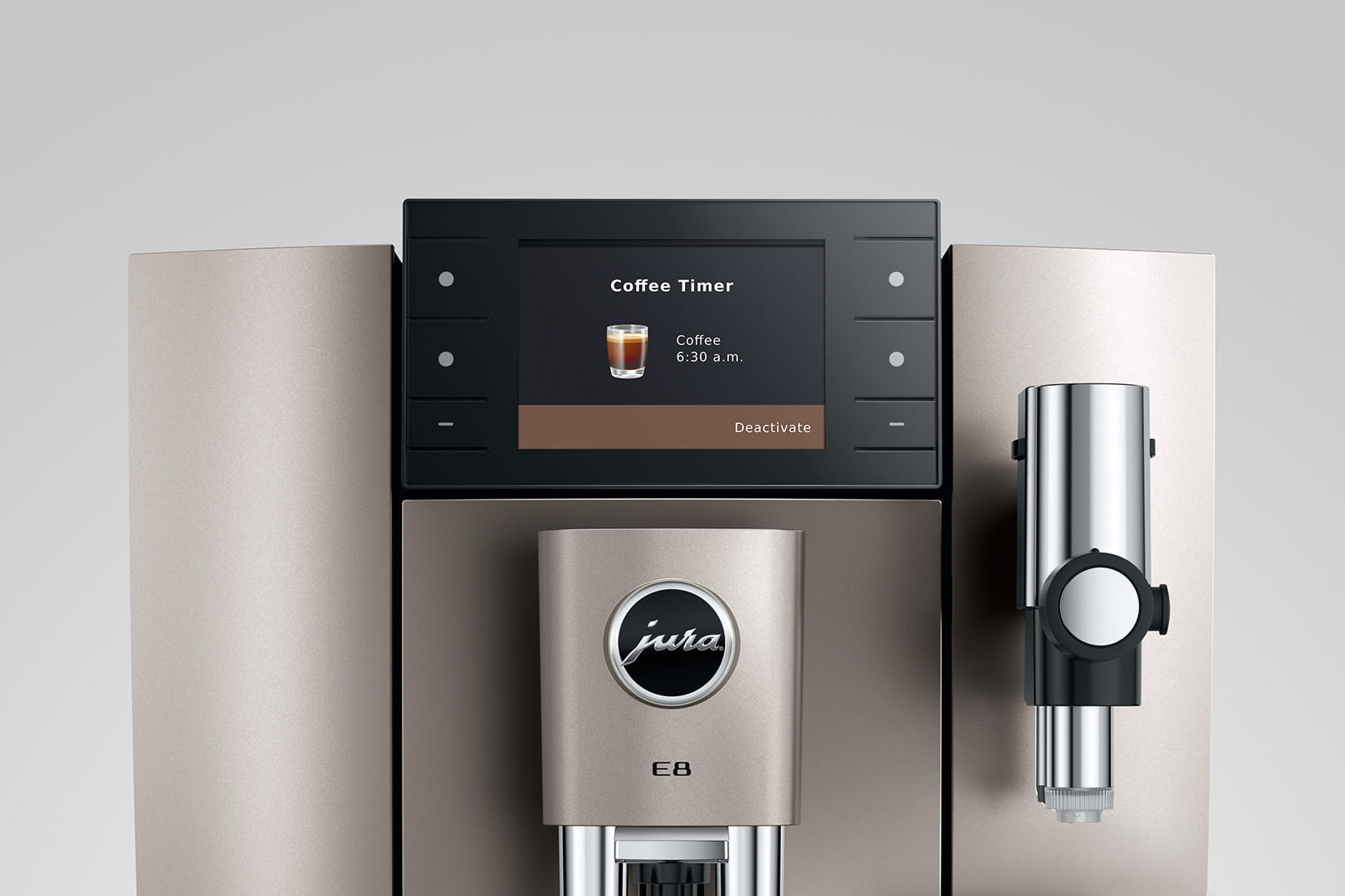 Una macchina da caffè mostra 'Coffee Timer' sullo schermo. Viene visualizzata un'icona di tazza di caffè e 'Coffee 6:30 a.m.'. La macchina è grigia.