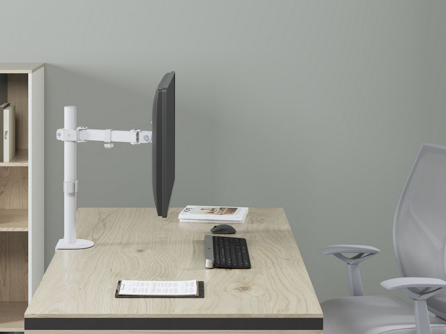 Configuration de bureau avec moniteur, clavier, souris et presse-papiers. Mur et chaise gris. Étagère à gauche. Support de moniteur blanc.