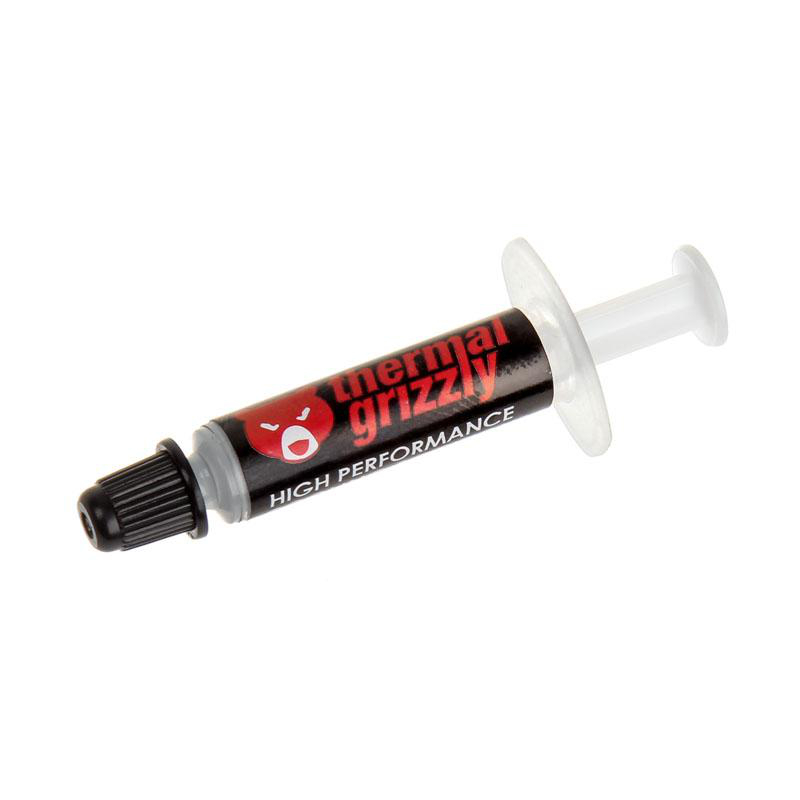 Eine Spritze mit Wärmeleitpaste, beschriftet mit 'thermal grizzly' und einem Bärenlogo, schwarze Tube mit weißem Kolben.