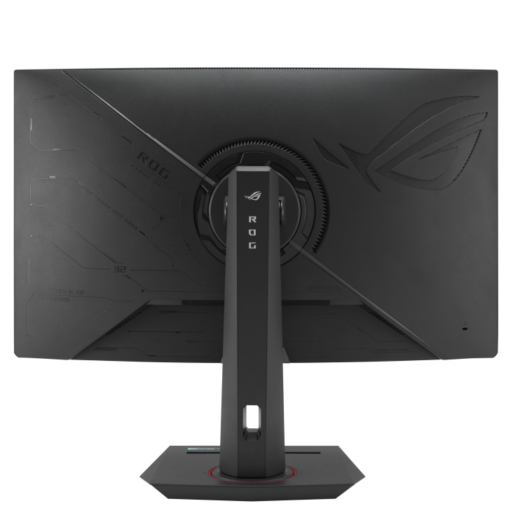 La parte trasera de un monitor de juegos ROG negro. Tiene un soporte, un logotipo y texto. El soporte tiene ROG escrito. El monitor está sobre fondo blanco.