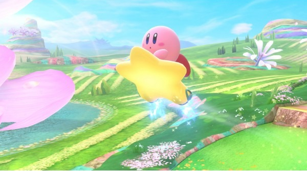 Kirby, personnage rose, vole avec une étoile dorée dans un paysage vibrant avec collines, fleurs et ciel bleu.