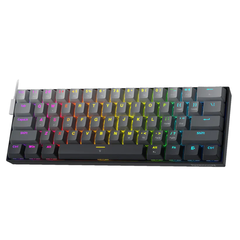 Wyświetlana jest czarna klawiatura z wielokolorowymi klawiszami. Klawisze są podświetlane różnymi kolorami. Klawiatura znajduje się na czarnej powierzchni.