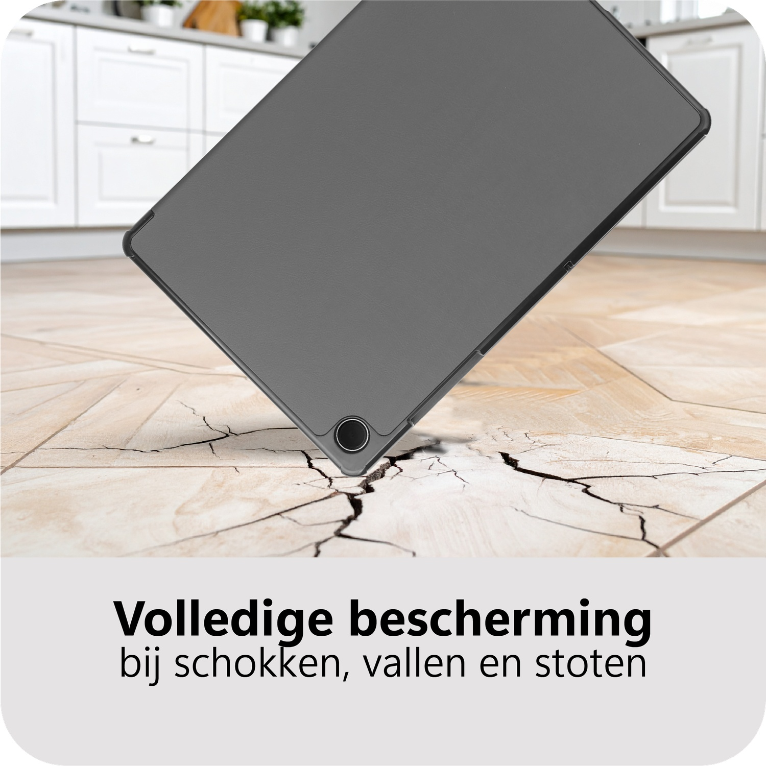 A gray tablet case is falling onto a cracked wooden floor. Kitchen cabinets are in the background. Text below reads 'Full protection'.
