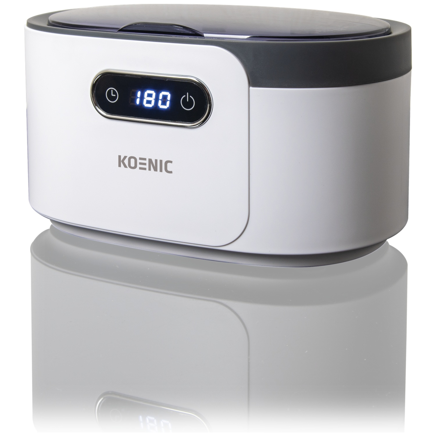 Een witte en grijze Koenic ultrasone reiniger met een digitaal display met '180'. Het apparaat reflecteert op een wit oppervlak.