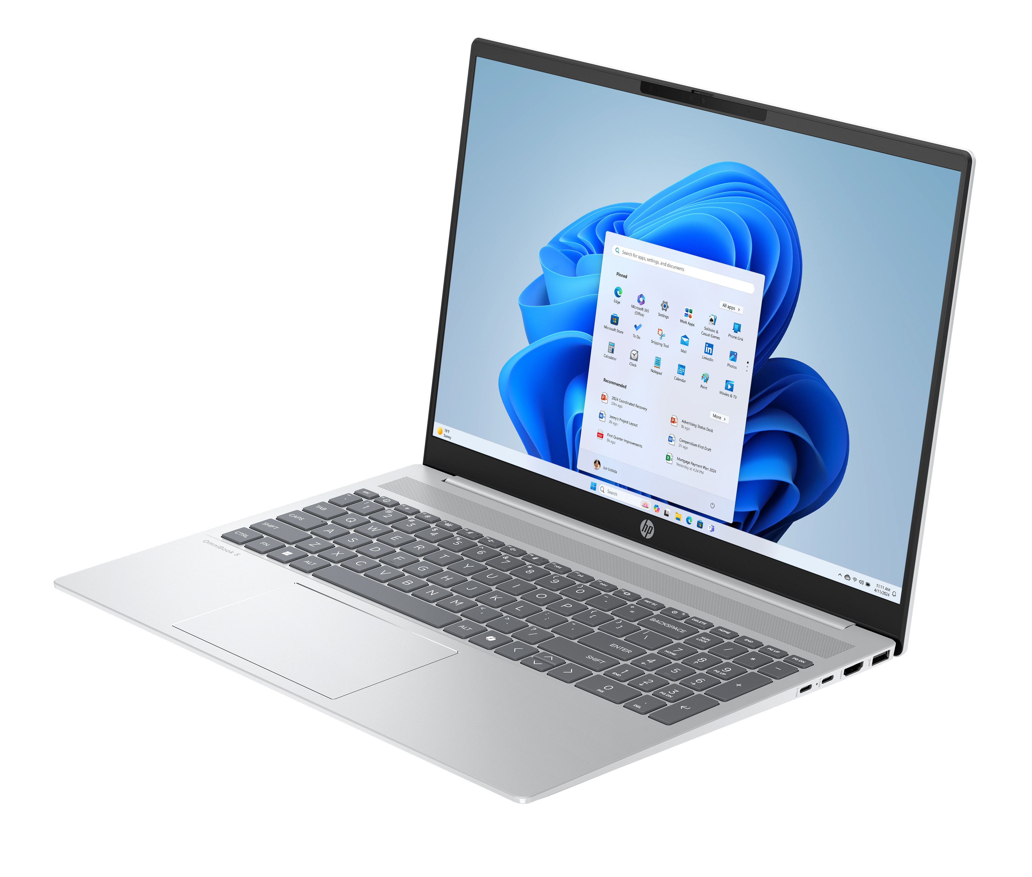 Srebrny laptop HP na czarnym tle, ekran Windows 11, widoczna klawiatura. Ekran pokazuje ikony aplikacji.