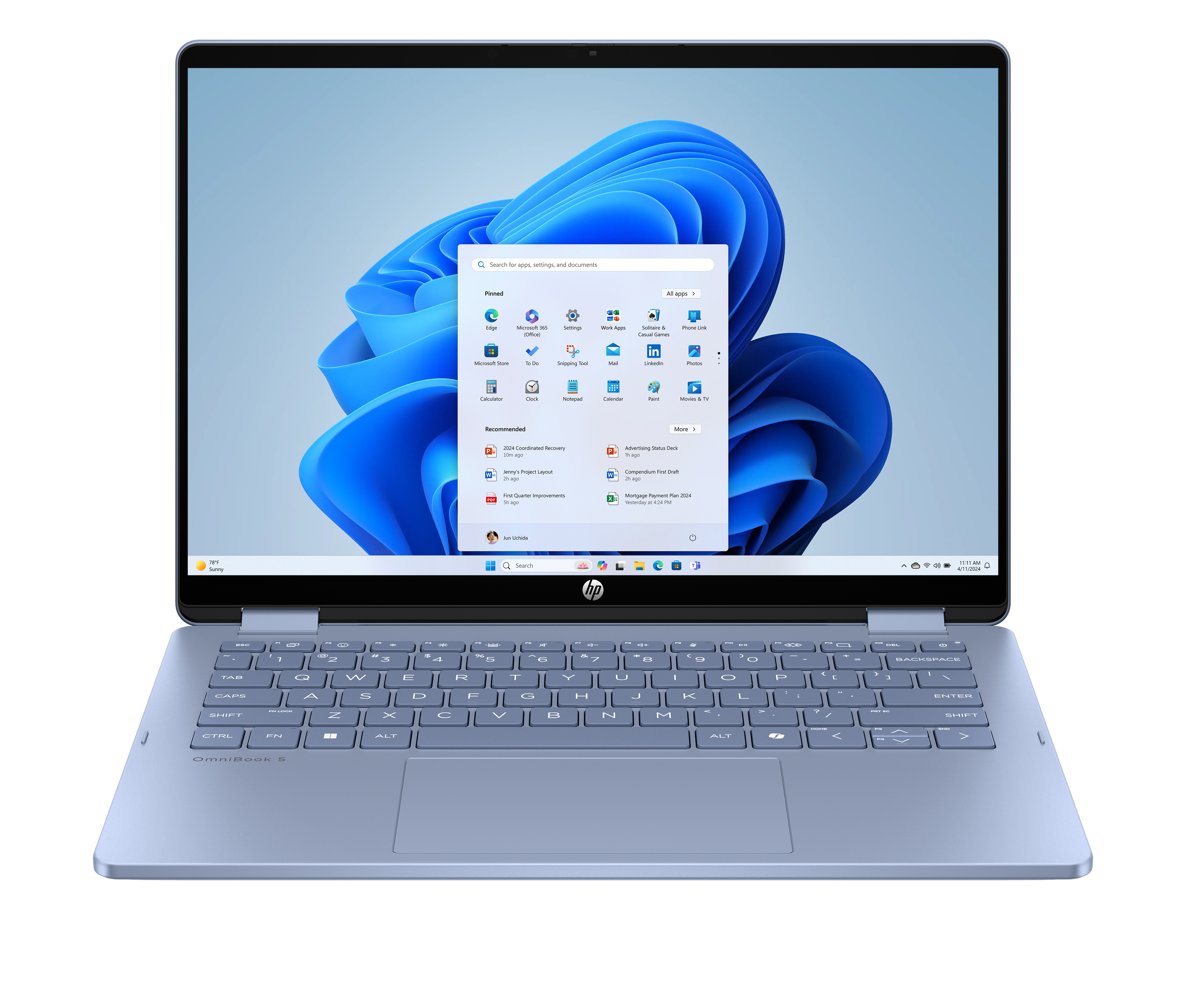 Otwarty laptop z interfejsem Windows 11. Ekran pokazuje aplikacje. Klawiatura i touchpad są widoczne.