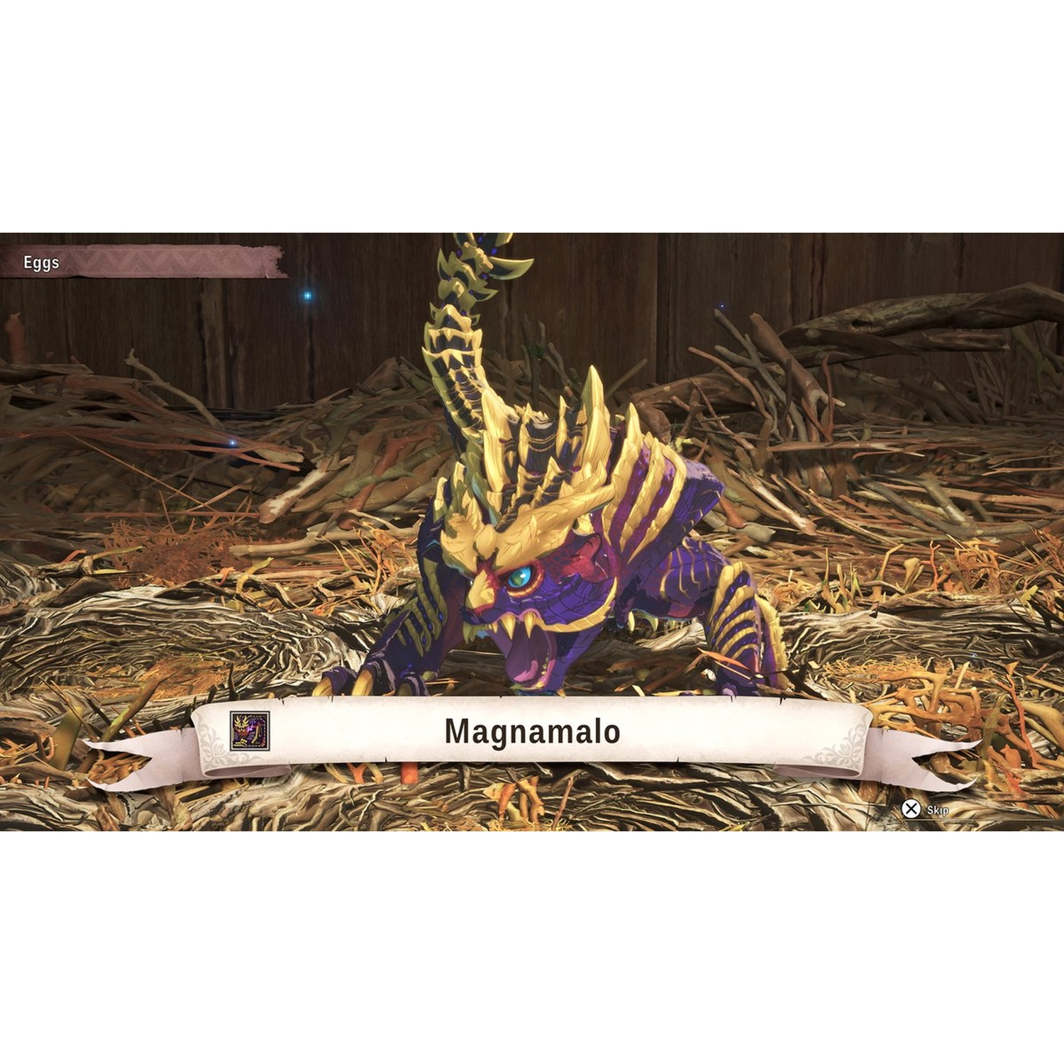 A purple and gold monster named Magnamalo is in a nest. The background is a wooden wall, the foreground is dried leaves and sticks.