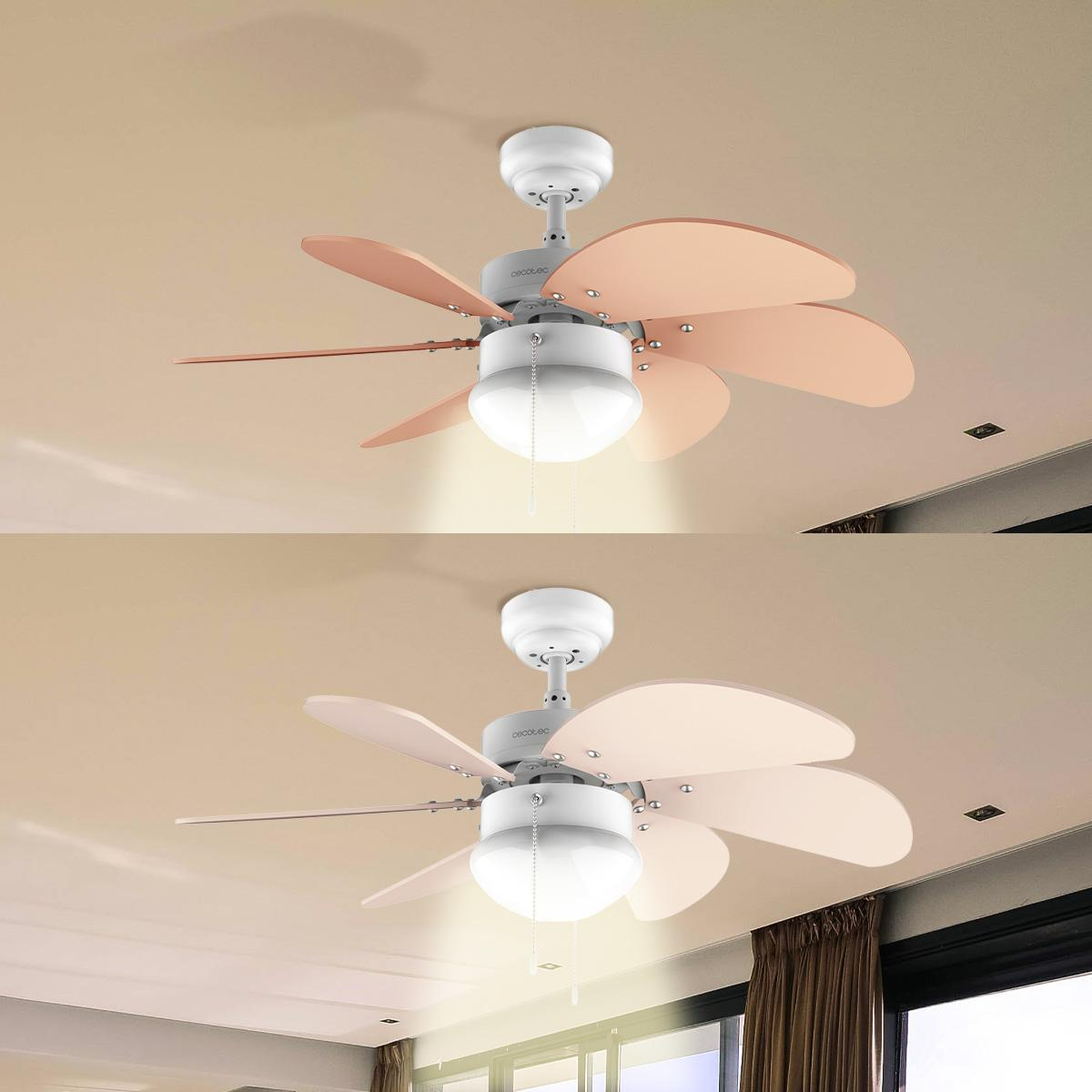 Ventilador de techo con aspas rosas y una lámpara, montado en un techo beige. El ventilador es el foco central de la imagen.