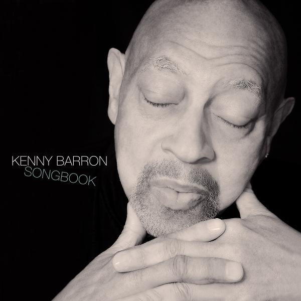 Ein glatzköpfiger Mann mit geschlossenen Augen, Ziegenbart und verschränkten Händen. Der Text lautet 'KENNY BARRON SONGBOOK'.