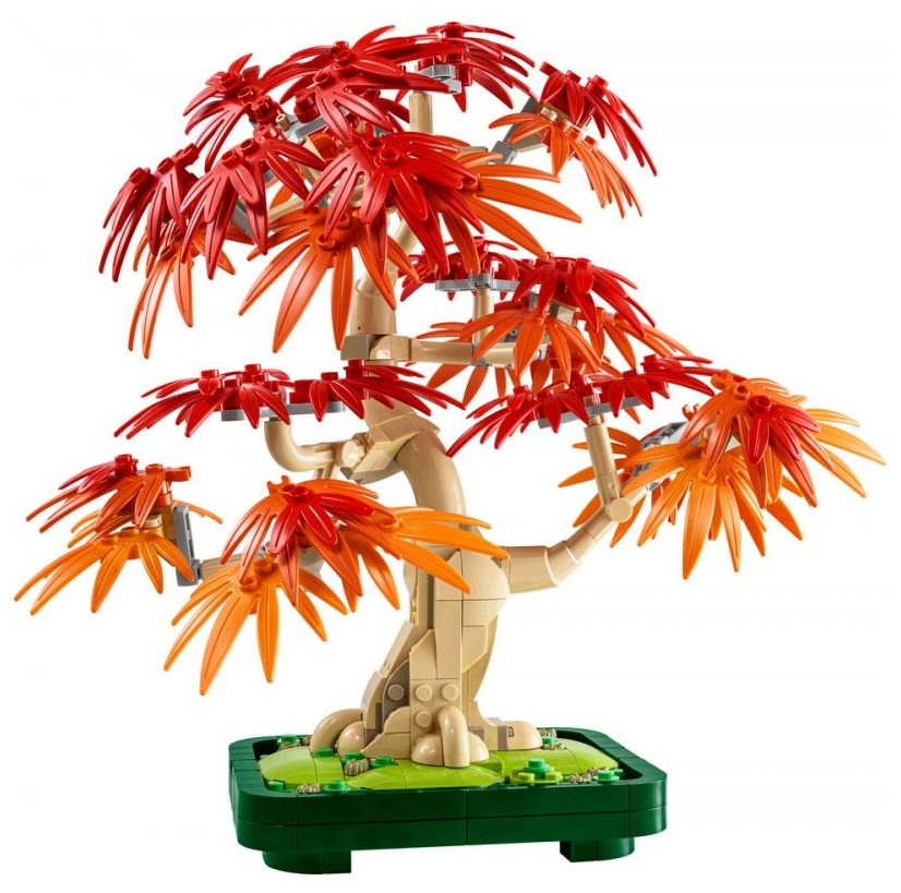 Bonsai Lego z czerwonymi i pomarańczowymi liśćmi. Pień jest beżowy, a podstawa zielona. Tło jest białe.