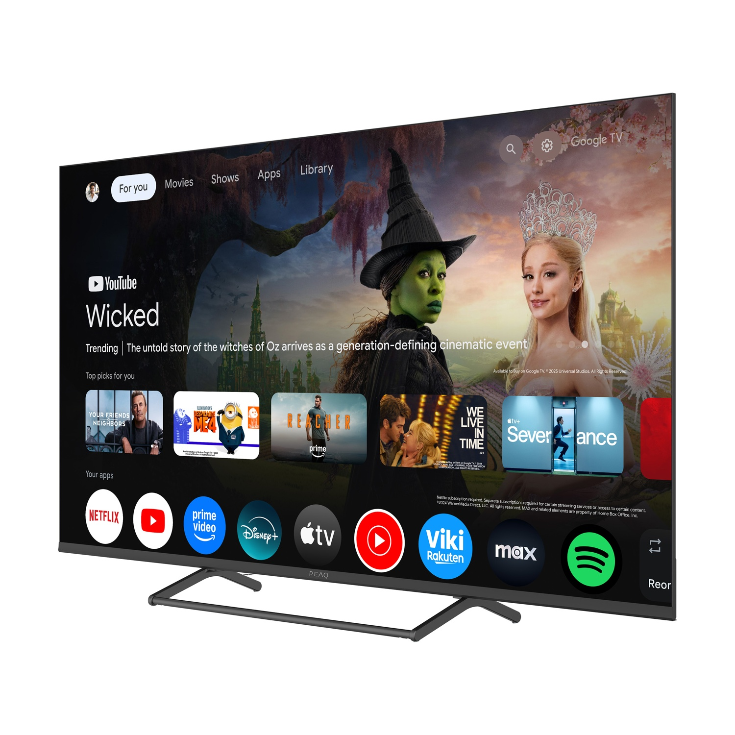 Un televisore mostra la promozione del film 'Wicked'. Sono visibili icone di app come Netflix, YouTube, Prime Video.