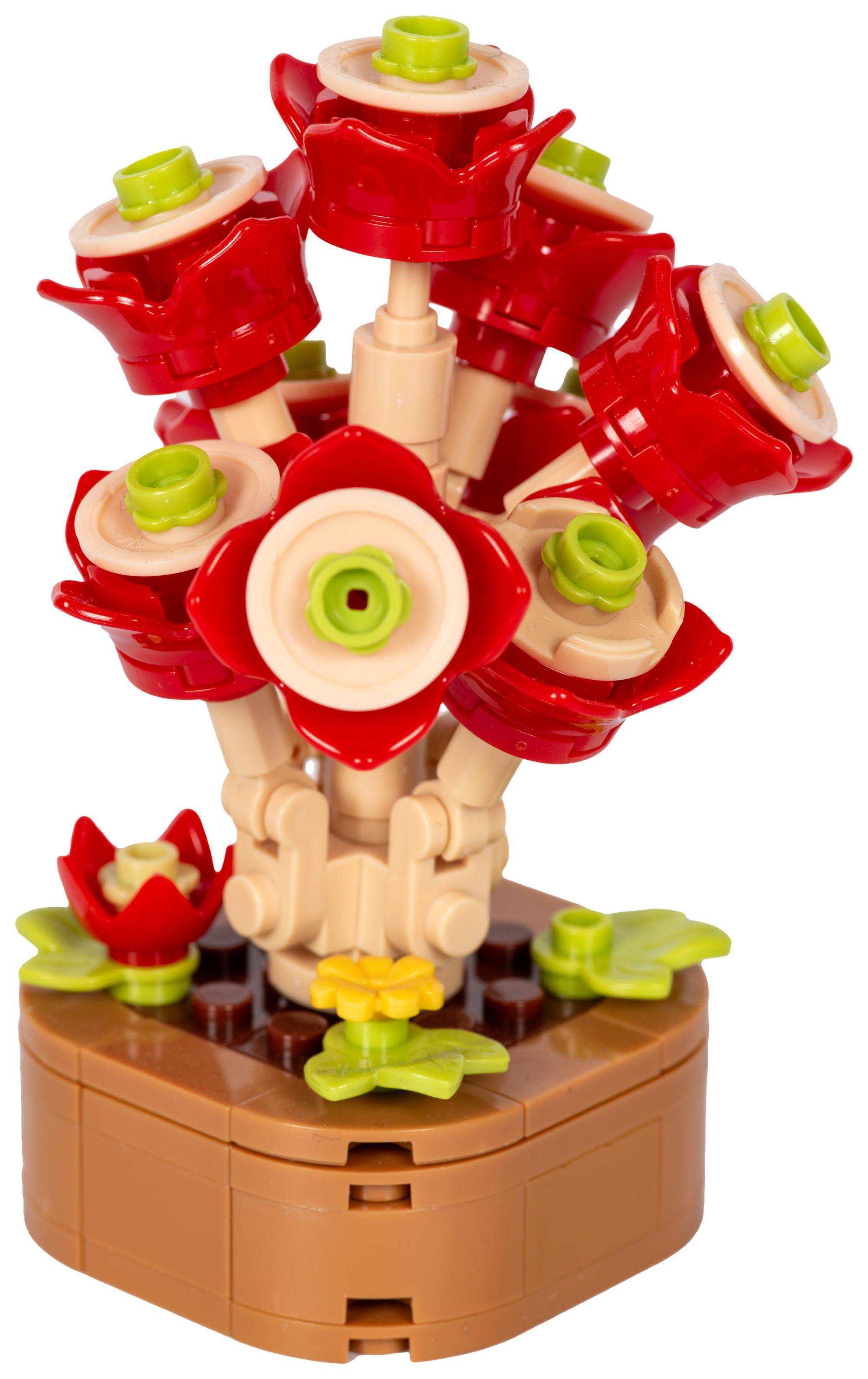 Ein Lego-Blumenarrangement. Rote Blumen mit grünen Zentren und Akzenten in einem braunen Topf.