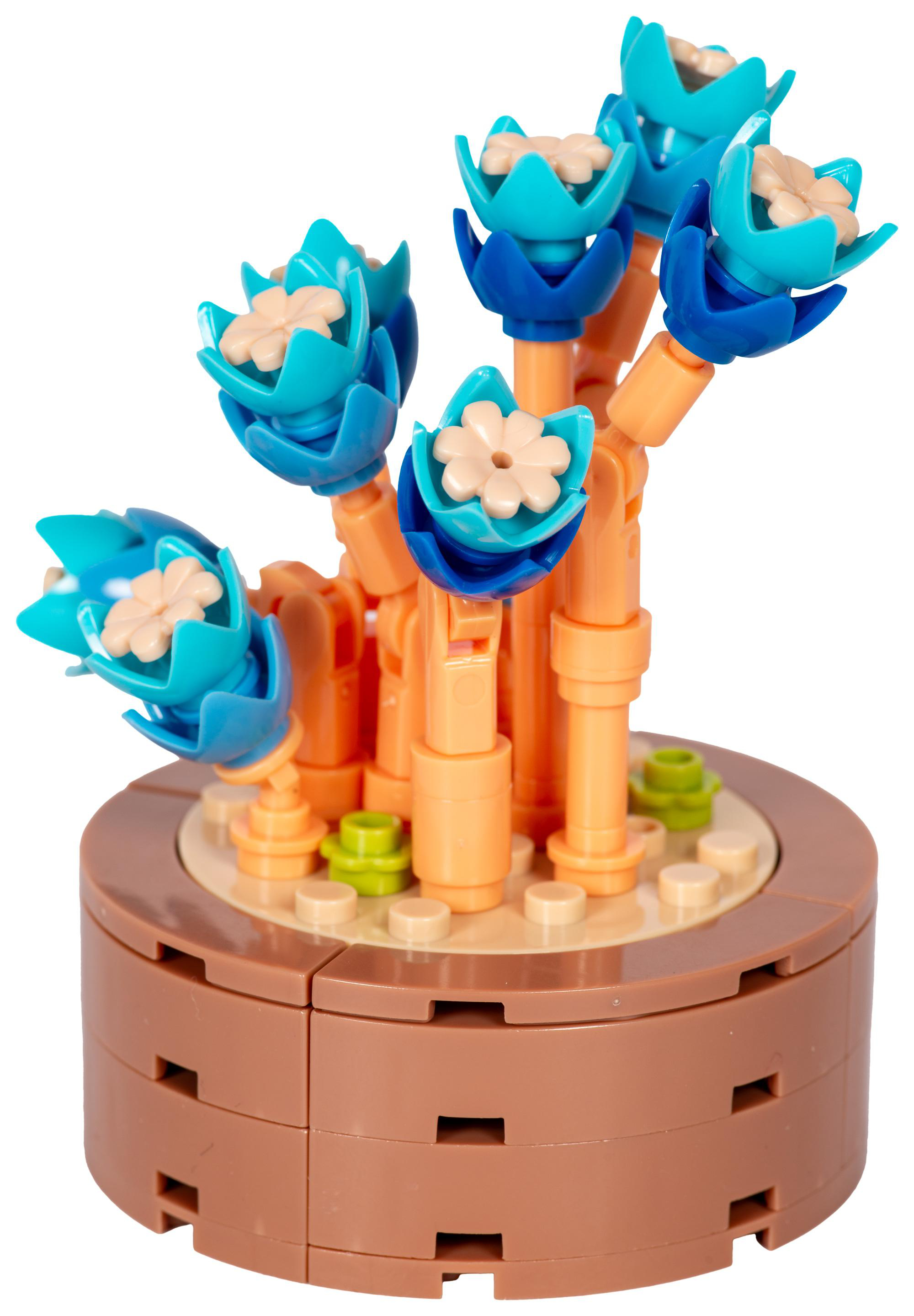 Ein Lego-Blumenarrangement. Es hat blaue Blüten mit hellbraunen Zentren und einen braunen Sockel.