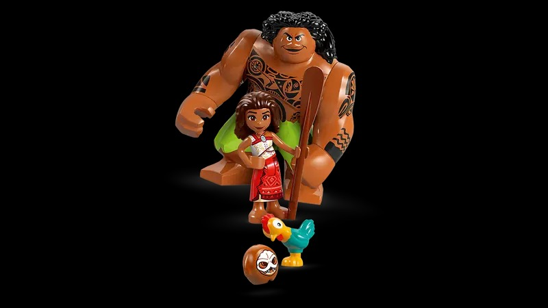 Lego set with Maui, Moana, a chicken, and a coconut. Maui is large with tattoos. Moana holds a staff.