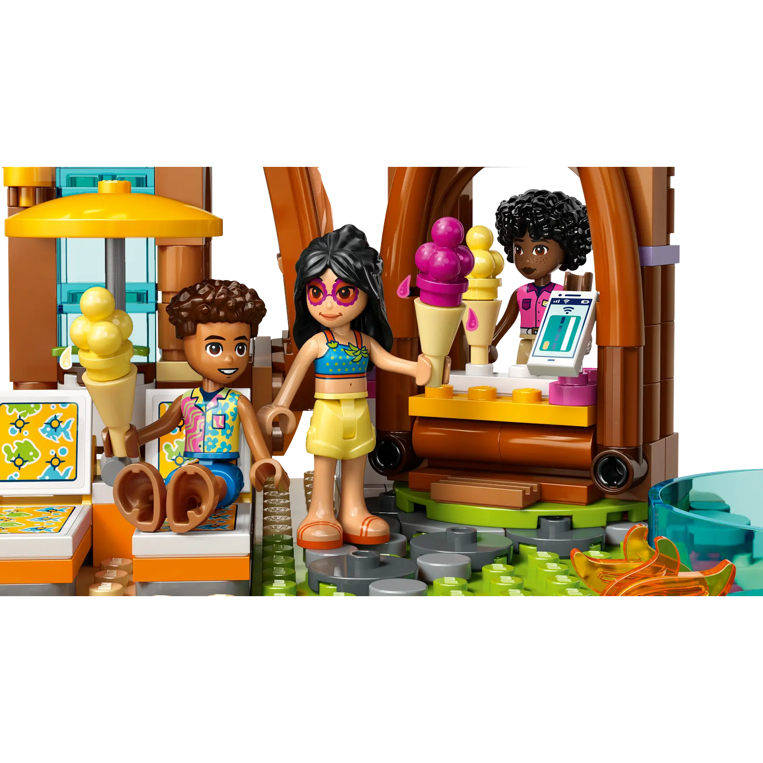 Lego set depicting an ice cream stand. Three Lego figures interact near the stand with ice cream cones.