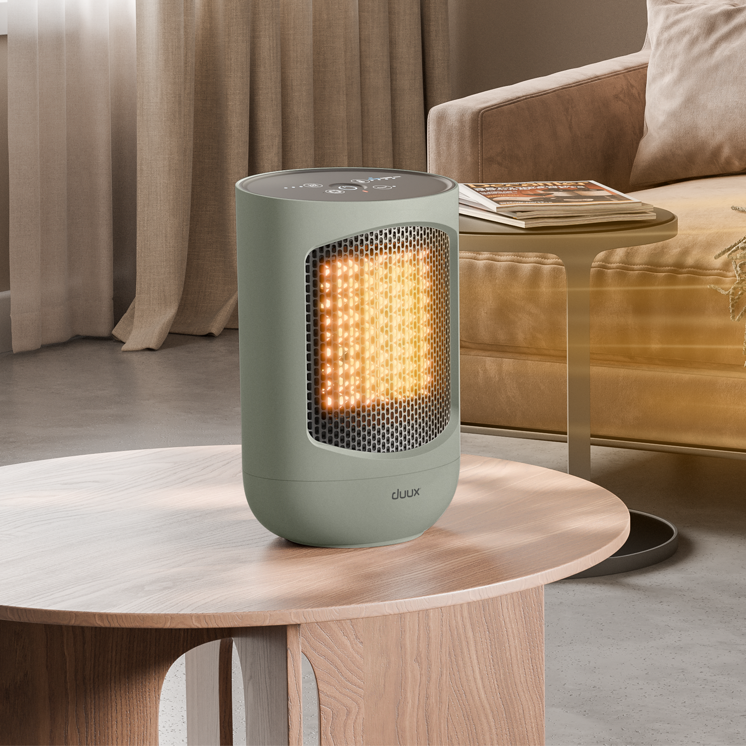 A green heater on a wooden table. The heater has a glowing interior. A sofa and a side table with magazines are in the background.