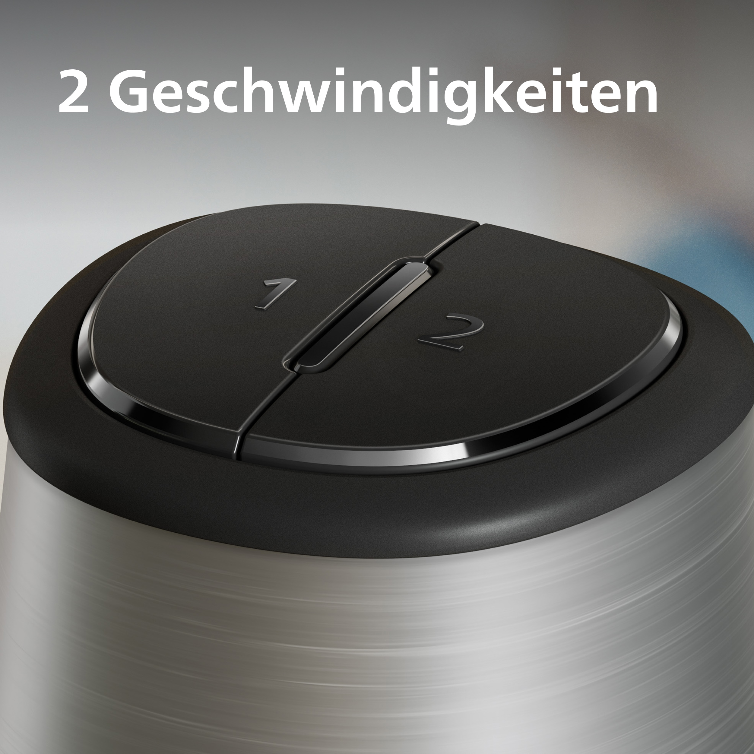 Nahaufnahme eines schwarzen Drehknopfs mit den Zahlen 1 und 2. Der Text oben lautet '2 Geschwindigkeiten'.