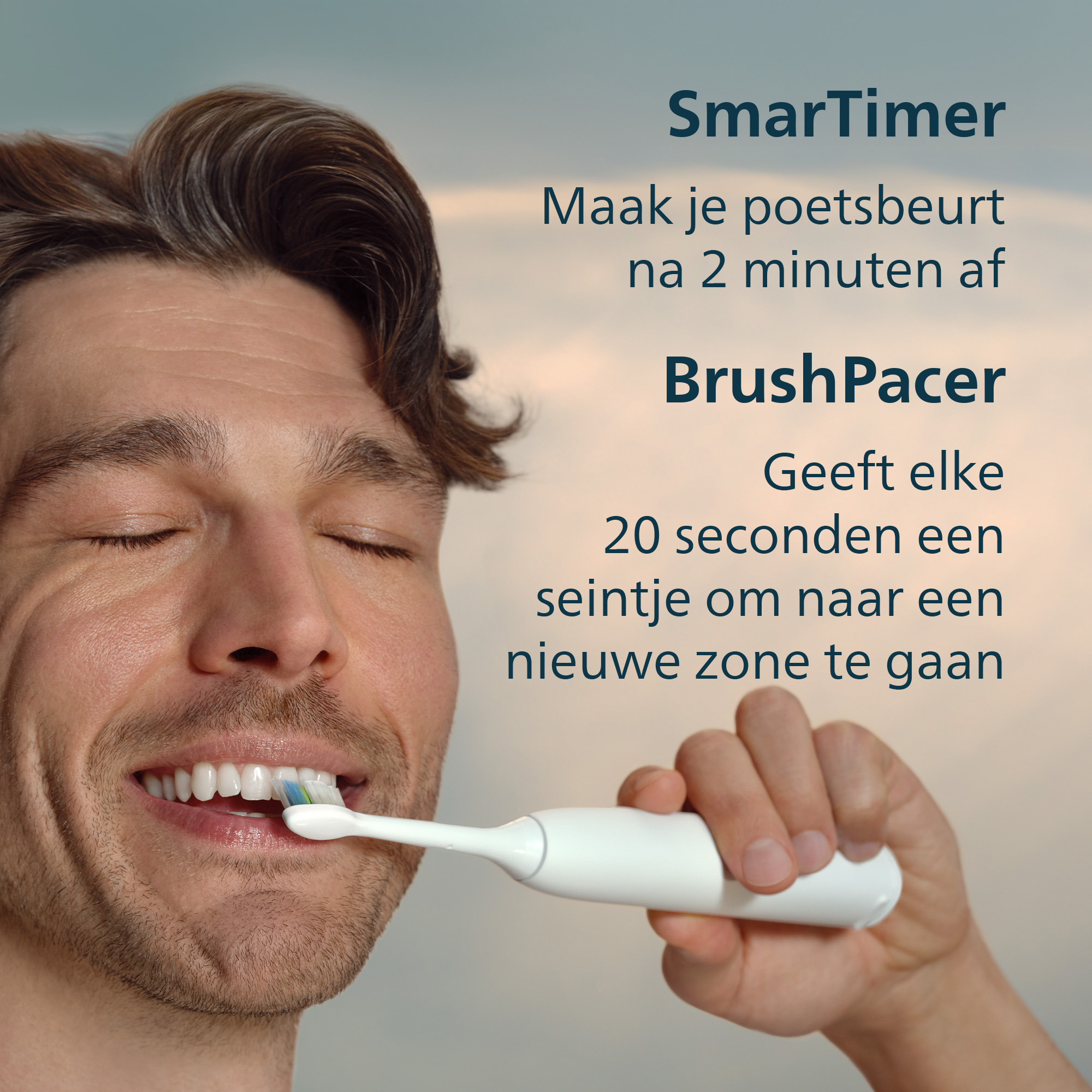 Man brushing teeth with a white electric toothbrush. The man has closed eyes and is smiling.