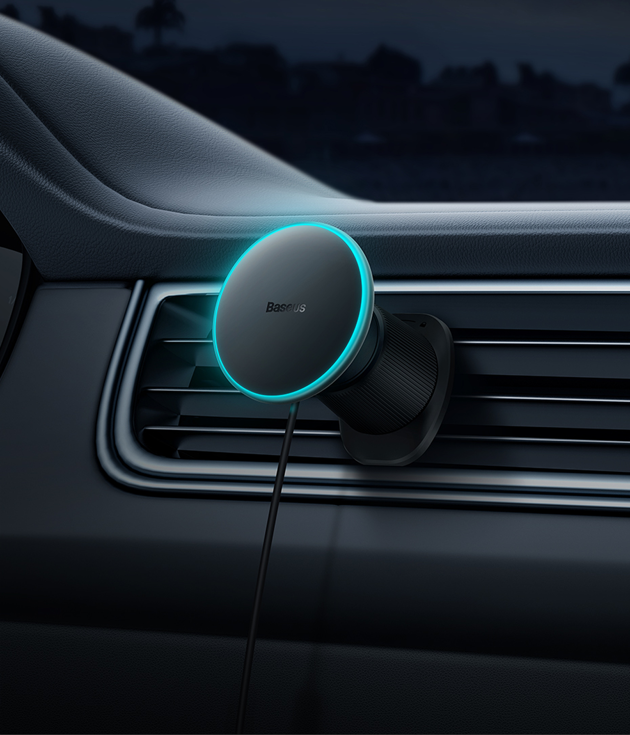 Un soporte negro para teléfono de coche Baseus con un anillo azul brillante, montado en una rejilla de ventilación. Un cable negro se extiende hacia abajo.